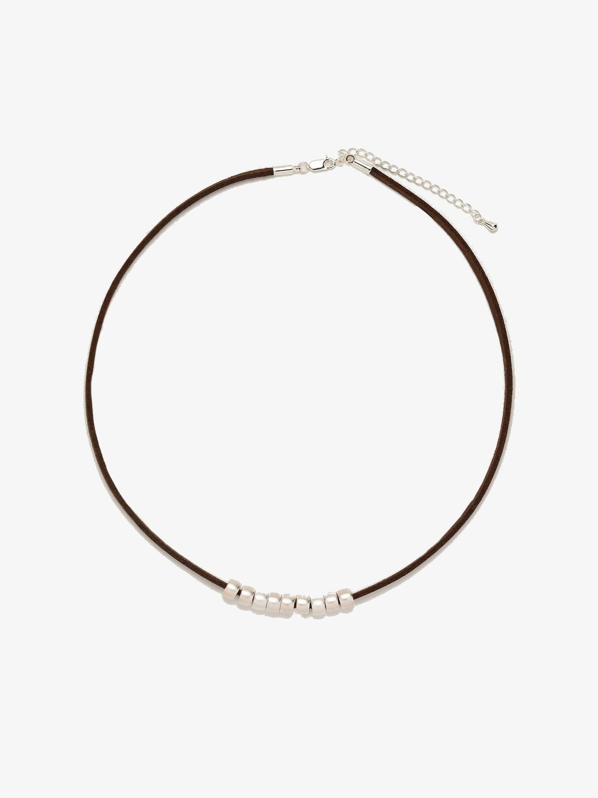 Fairyokai Balance Glide necklace with brown leather cord and textured silver bead on white background.
