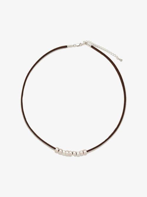 Fairyokai Balance Glide necklace with brown leather cord and textured silver bead on white background.