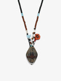 Fairyokai Culling the Cream agate vase pendant necklace on white background.
