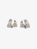 Pair of Fairyokai Double Arc sculptural open C-shape hoop earrings with white gold tone plating on white background.