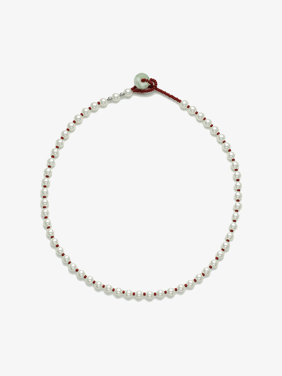 Fairyokai Lunar Chord Czech bead and jade pearl necklace (red) on white background.