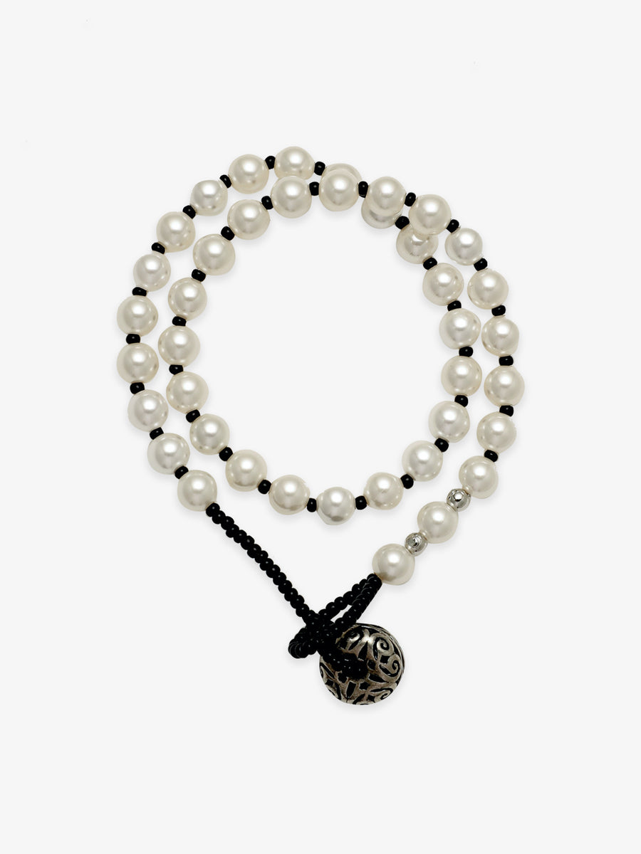 One Fairyokai Lunar Chord double-layer faux pearl bracelet on a clean white background, with two strands of faux pearls and a black cord closure.