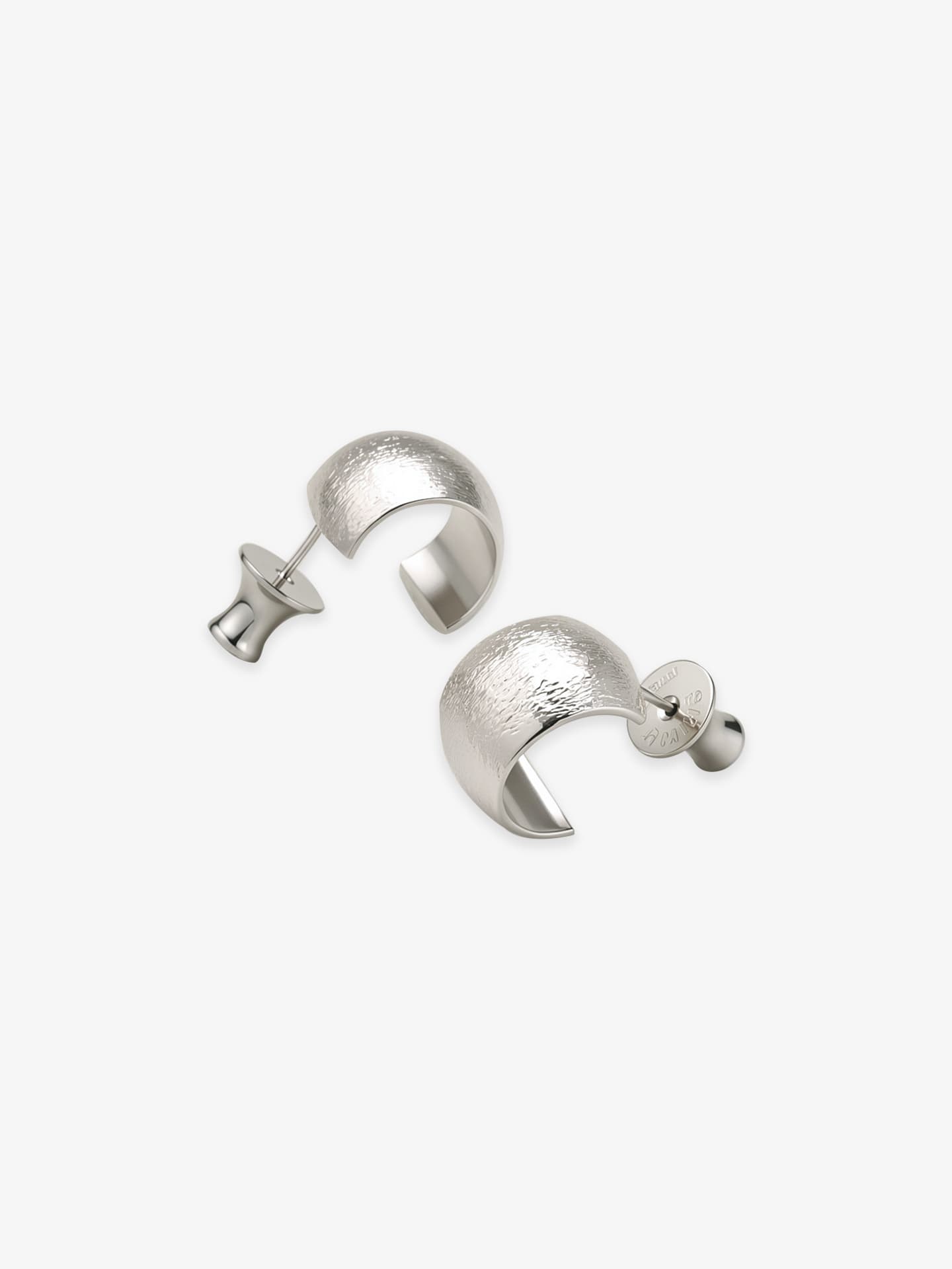 Pair of Fairyokai Moon Trace sand-textured C-shape hoop earrings with S925 silver posts on white background.