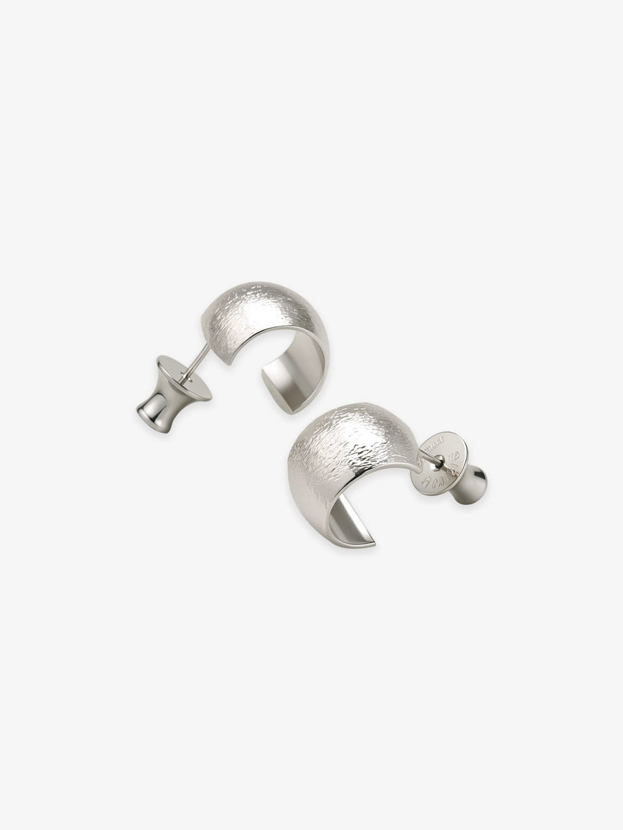 Pair of Fairyokai Moon Trace sand-textured C-shape hoop earrings with S925 silver posts on white background.