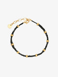 One Fairyokai Rhythm Between double-layer black spinel bracelet on a clean white background, with black beads, gold-tone accents, and adjustable cord ends.