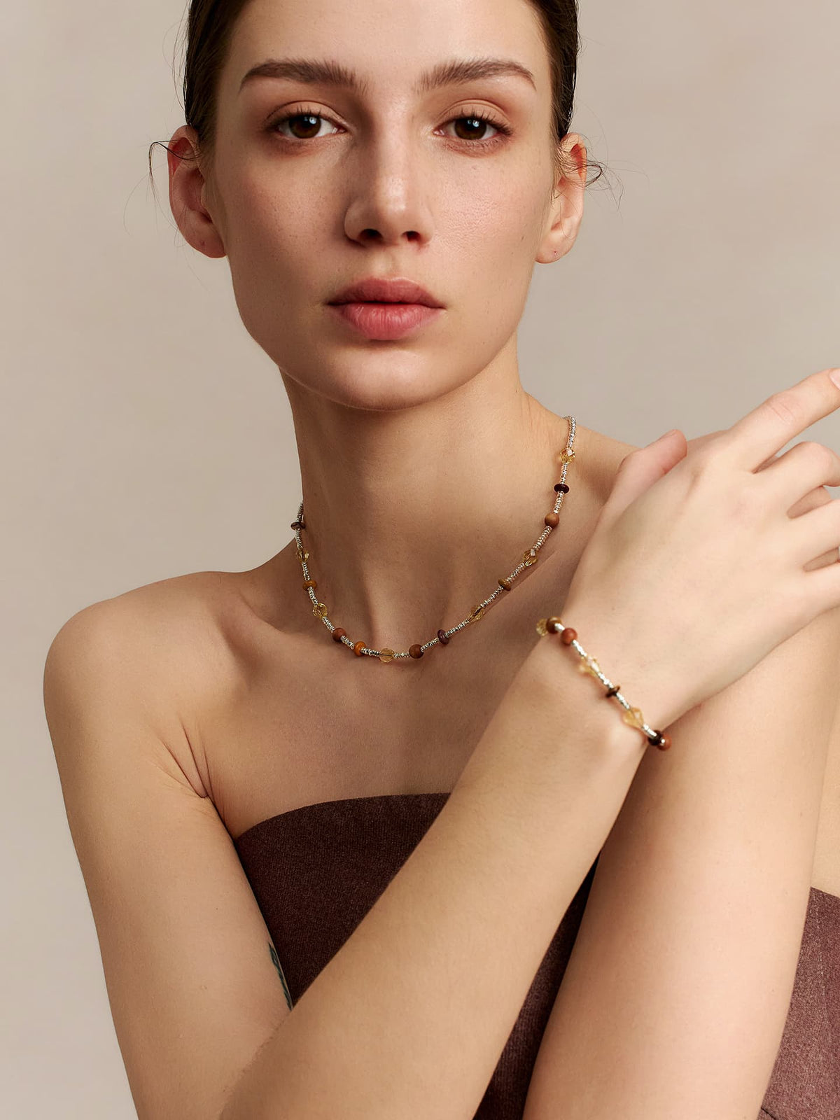 Model wearing the Fairyokai Soft Pure Light mixed stone braided bracelet with a matching natural stone necklace, hand resting near the shoulder.
